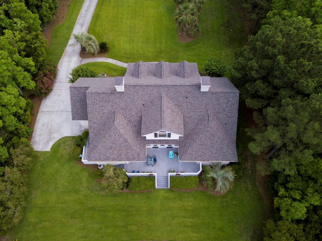aerial-view-of-large-home-with-new-roof-on-beautif-2021-08-26-16-22-44-utc